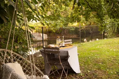 a table with wine bottles and glasses on it at Maison Loutina, Villa 5 min à pied du centre in LʼIsle-sur-la-Sorgue