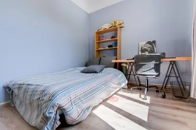 a bedroom with a bed and a desk and a chair at Le Blondel in Aix-en-Provence