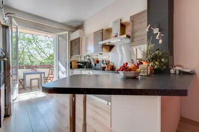 a kitchen with a counter with a bowl of fruit on it at Le Blondel in Aix-en-Provence