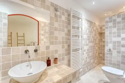 a bathroom with a sink and a toilet and a mirror at Le mas sous les étoiles in Joucas