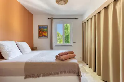 a bedroom with a bed and a window at Le mas sous les étoiles in Joucas