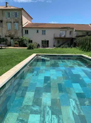 a swimming pool in front of a house at L'appart des Anges in Althen-des-Paluds