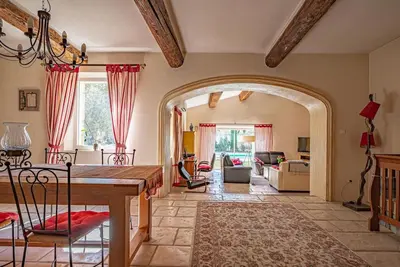 a living room with a table and a dining room at Villa de Minna in Robion en Luberon