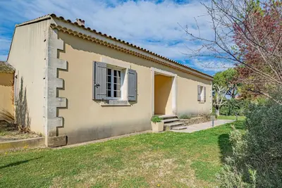 a kitchen with a wooden table and a dining room at Villa de Minna in Robion en Luberon