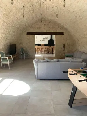 a living room with a couch and a table at Mas en campagne in Mallemort