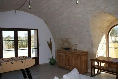 a room with a bed and a table and windows at Mas en campagne in Mallemort