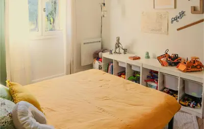 a bedroom with a bed with a large yellow blanket at Nice Home In Pernes-Les-Fontaines in Pernes-les-Fontaines