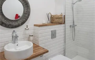 a bathroom with a sink and a shower with a mirror at Nice Home In Pernes-Les-Fontaines in Pernes-les-Fontaines