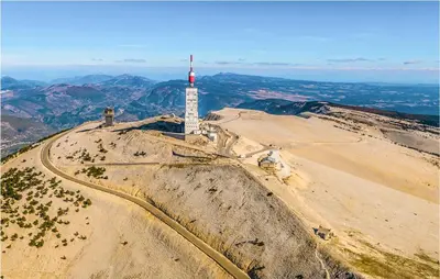 a mountain with a red and white tower on it at Nice Home In Pernes-Les-Fontaines in Pernes-les-Fontaines