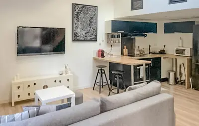 a living room with a couch and a kitchen at Nice Home In Pernes-Les-Fontaines in Pernes-les-Fontaines
