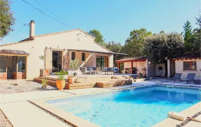 a home with a swimming pool and a house at Nice Home In Pernes-Les-Fontaines in Pernes-les-Fontaines