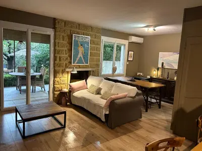 a living room with a couch and a table at Nid d'Ange en Provence in Cavaillon