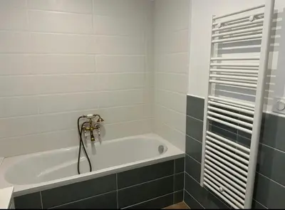 a bathroom with a bath tub with a shower at L’Amistouso in Vedène