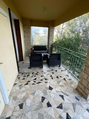 a patio with chairs and a couch on a balcony at L’Amistouso in Vedène