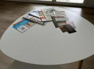 a white table with magazines and newspapers on it at L’Amistouso in Vedène