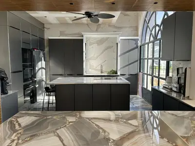 a kitchen with black cabinets and a ceiling fan at Maison d Hotes BLUE PALM Aix en PROVENCE in Aix-en-Provence