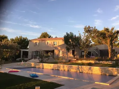 a house with a swimming pool in front of a house at Villa des Fontaines luxury family home with pool in Pernes-les-Fontaines
