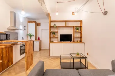 a kitchen and living room with a couch and a table at Charmant T2 centre in Aix-en-Provence