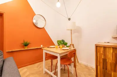 a dining room with a table and a mirror at Charmant T2 centre in Aix-en-Provence