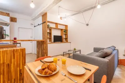 a living room with a table and a couch at Charmant T2 centre in Aix-en-Provence