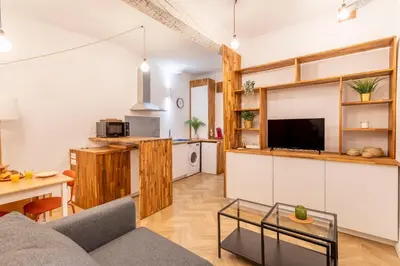 a living room with a couch and a table at Charmant T2 centre in Aix-en-Provence