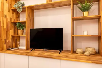 a flat screen tv on a shelf in a living room at Charmant T2 centre in Aix-en-Provence