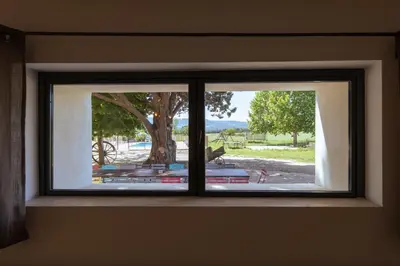 a window in a room with a view of a tree at Le Moulin de Lavon in Gargas