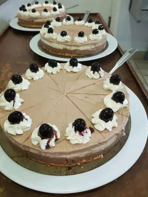 a chocolate cake on a table with other cakes at Le Moulin de Lavon in Gargas