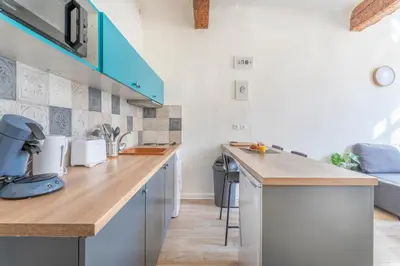 a kitchen with a wooden counter top in a room at Studio place cardeurs in Aix-en-Provence