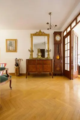 a large wooden cabinet in a room with a couch at Le Jourdan clim' terrasse ascenseur garage in Aix-en-Provence