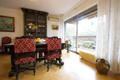 a kitchen with white cabinets and a stove at Le Jourdan clim' terrasse ascenseur garage in Aix-en-Provence