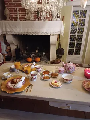 a table with plates of food and bowls on it at Chambre d hôte Lavande 
