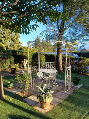 a gazebo with a table and chairs in a yard at Chambre d hôte Lavande 