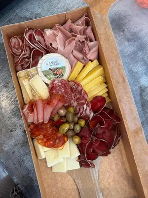 a box filled with different types of meats and cheese at Chambre d hôte Lavande 