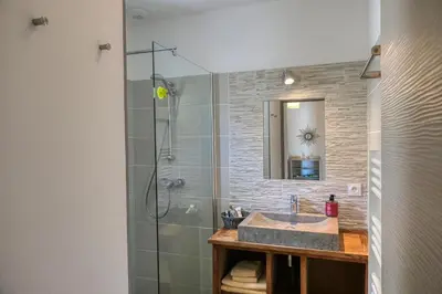 a bathroom with a sink and a shower at Souleia in Oppède