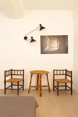two chairs and a table in a room at Maison de village Arty et terrasse au calme in Lourmarin
