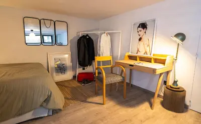 a bedroom with a desk and a bed at l'Instant Parfait in Aix-en-Provence