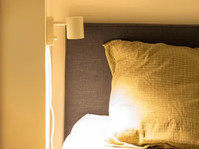 a bedroom with a bed with a pillow and a lamp at l'Instant Parfait in Aix-en-Provence