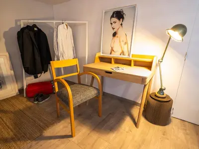 a desk with a lamp and a chair in a room at l'Instant Parfait in Aix-en-Provence