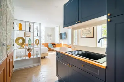 a kitchen with blue cabinets and a sink at La Réserve de Salon de Provence in Salon-de-Provence