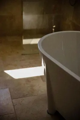 a bathroom with a bath tub in a room at Unique guest room in the heart of Provence 