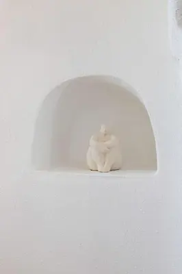 a white sculpture of a person sitting on a wall at Unique guest room in the heart of Provence 