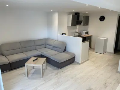 a living room with a couch and a table at Joli logement au pied des Alpilles in Eyguières