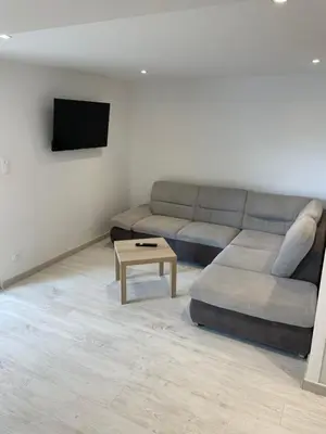a living room with a couch and a coffee table at Joli logement au pied des Alpilles in Eyguières