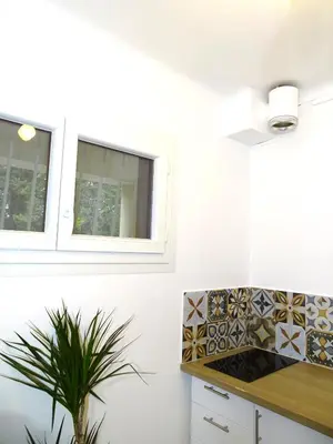 a kitchen with white walls and a counter with a plant at TILIA JOURDAN-Studio Cosy Aix Centre-Cours MIRABEAU-PARKING-WIFI-SMART TV-RUE CALME in Aix-en-Provence