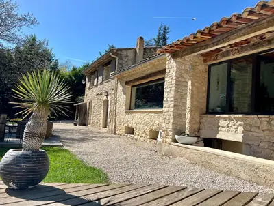 a house with a palm tree in front of it at Gîte Nature en Luberon in Céreste
