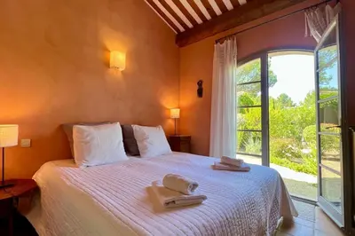 a bedroom with a bed with two towels on it at Maison Marie Provençal Elegance on the Pont Royal Golf Course in Mallemort