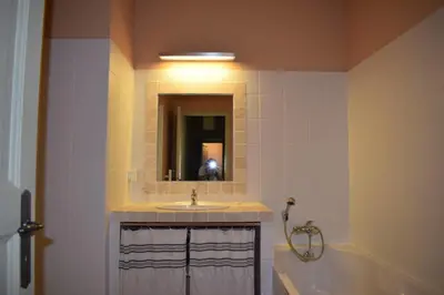 a bathroom with a sink and a tub and a mirror at Maison Marie Provençal Elegance on the Pont Royal Golf Course in Mallemort