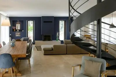 a living room with blue walls and a staircase at Bastide Blanche Villa with swimming pool and pétanque court in Lourmarin in Lourmarin