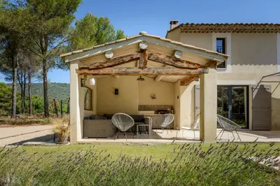 a gazebo with a table and chairs in front of a house at Bastide Blanche Villa with swimming pool and pétanque court in Lourmarin in Lourmarin